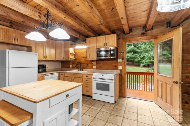 a kitchen with stainless steel appliances granite countertop a stove a sink dishwasher and a refrigerator with cabinets