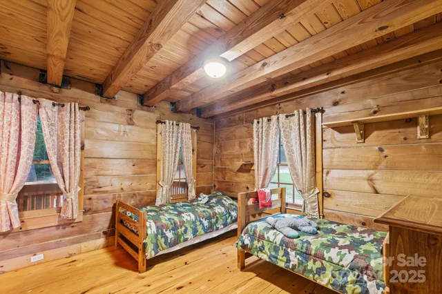 a bedroom with furniture and a large window