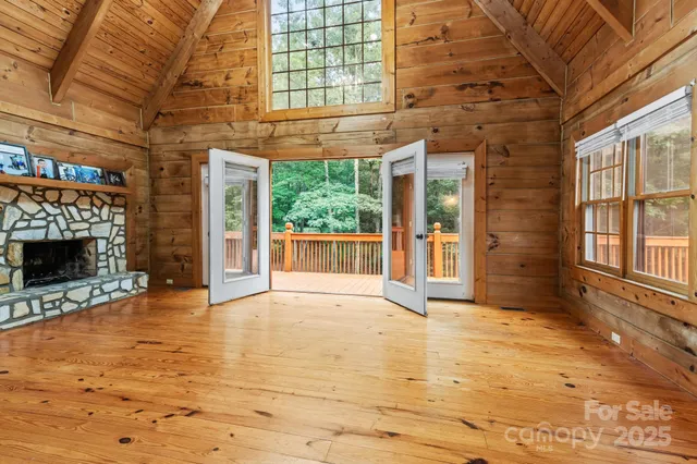 a view of an empty room with a fireplace and a window