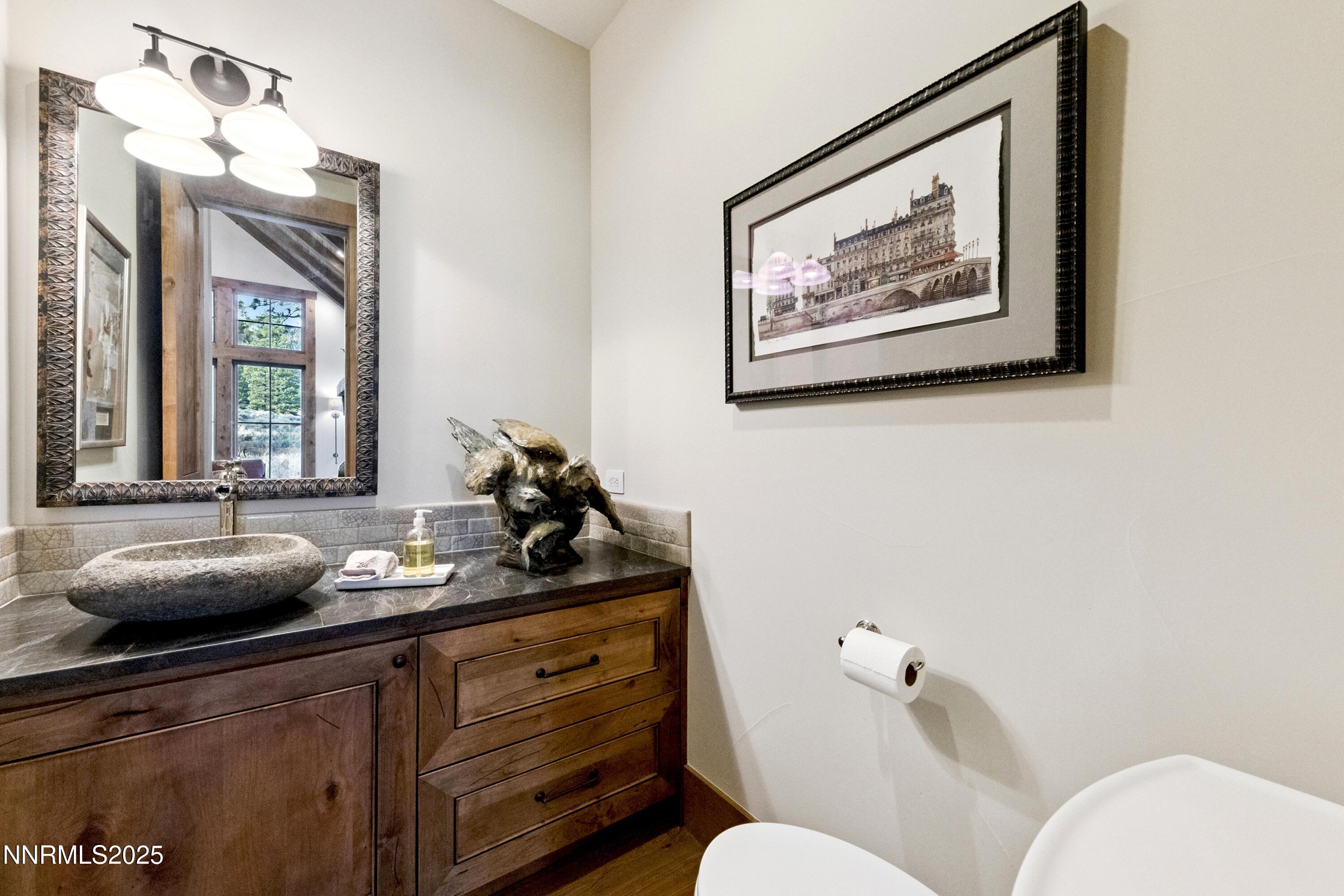 261 Redding Way Carson City, NV 89705 - Photo 28 of 90 a bathroom with a toilet sink and mirror
