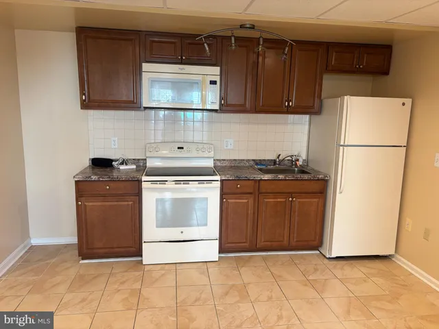 a kitchen with a stove a microwave and refrigerator