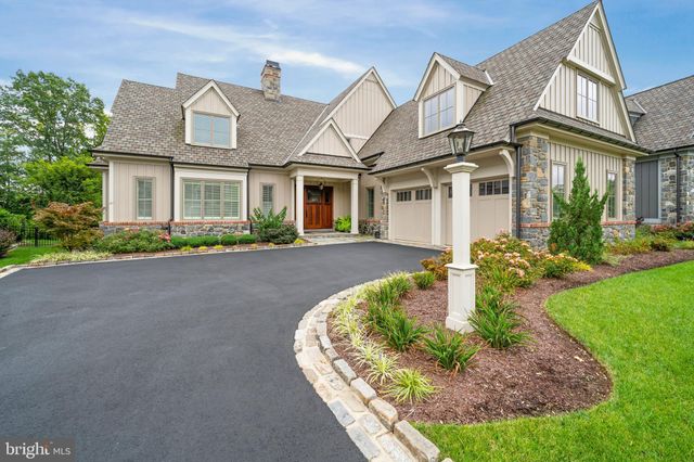 a view of a backyard with plants and a bench