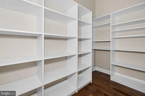 a spacious bedroom with a bed and a chandelier