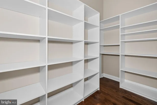 a spacious bedroom with a bed and a chandelier