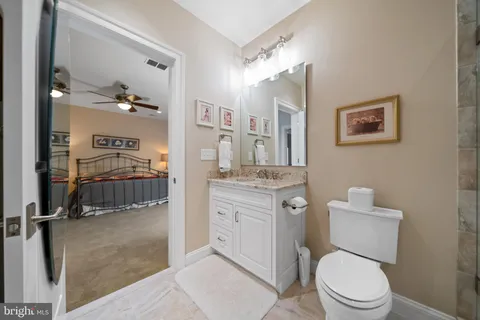 a spacious bathroom with a granite countertop sink a mirror and a shower