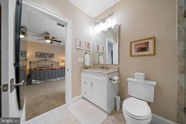 a spacious bathroom with a granite countertop sink a mirror and a shower