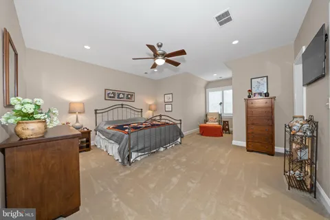 a spacious bathroom with a granite countertop sink a mirror a vanity and a shower
