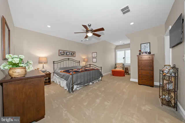 a spacious bathroom with a granite countertop sink a mirror a vanity and a shower