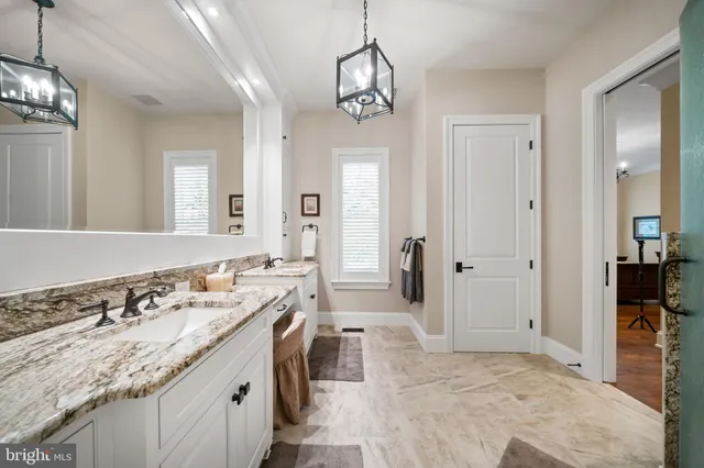 a kitchen with stainless steel appliances a dining table chairs stove and white cabinets