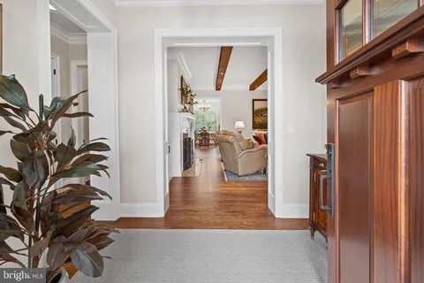 a living room with furniture a flat screen tv and a large window