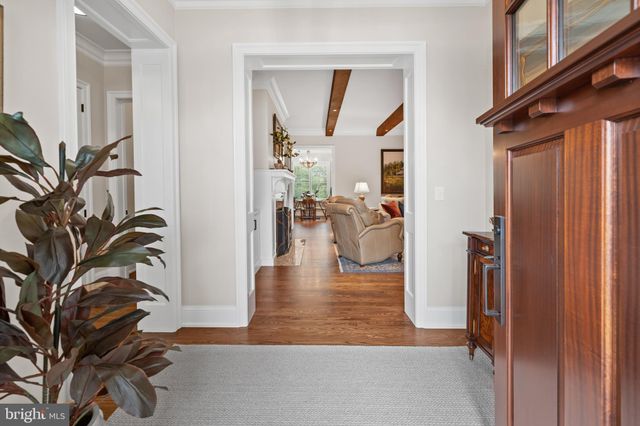 a living room with furniture a flat screen tv and a large window