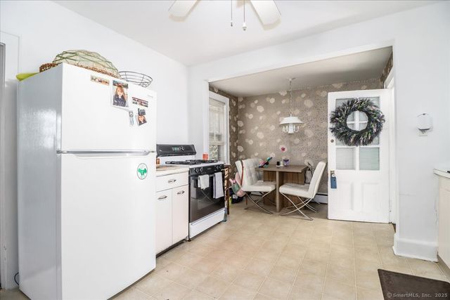 a kitchen with a refrigerator and a dining table
