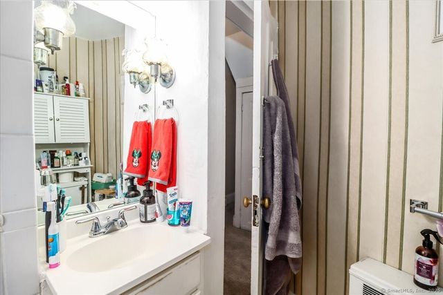 a bathroom with a sink vanity and a mirror