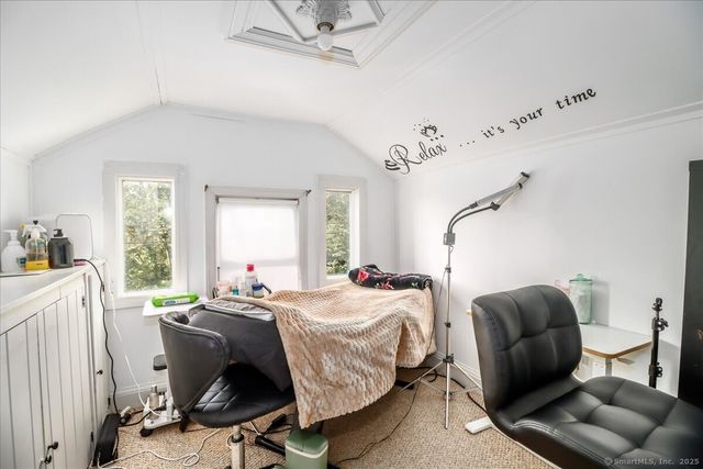 a bedroom with bed and windows