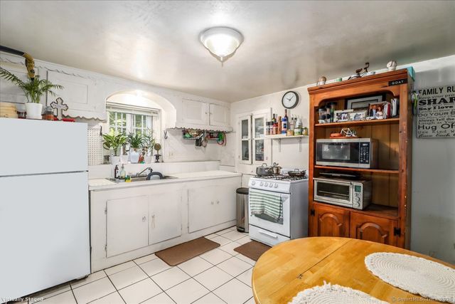 a kitchen with stainless steel appliances a sink and a refrigerator
