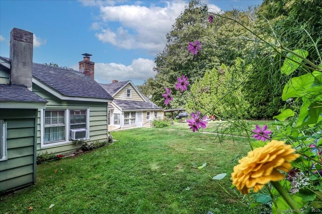 a view of a house with a backyard and garden