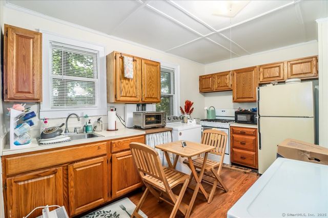 a kitchen with stainless steel appliances granite countertop a refrigerator sink and cabinets
