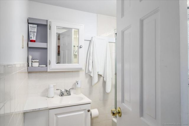 a bathroom with a sink vanity and a mirror