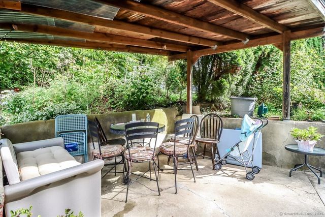 a patio with yard glass top table and chairs