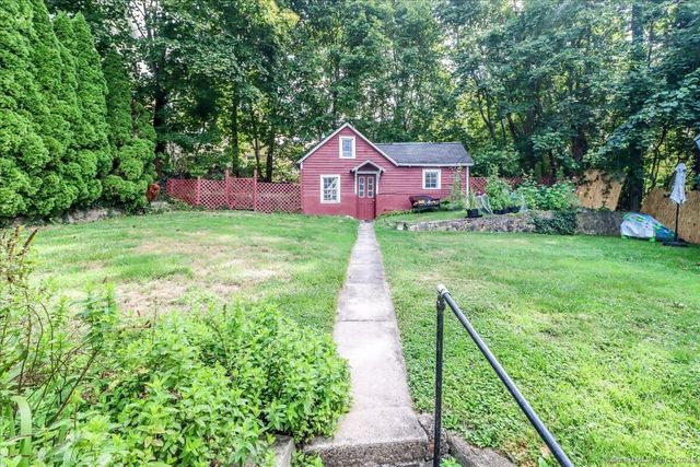 a pathway of a house with a yard