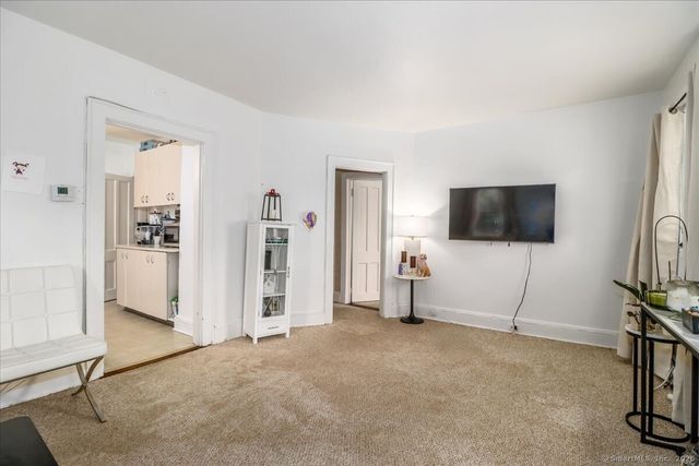 a view of a livingroom with furniture and a flat screen tv