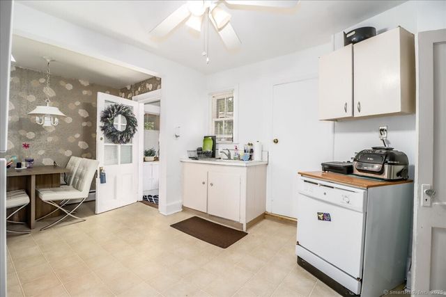 a kitchen with cabinets and wooden floor