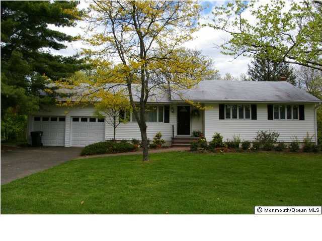 24 Chestnut Ridge Road Holmdel, NJ 07733 - Photo 1 of 3 a front view of a house with a garden