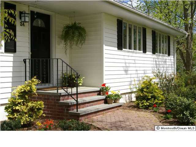 24 Chestnut Ridge Road Holmdel, NJ 07733 - Photo 2 of 3 a view of a house with potted plants