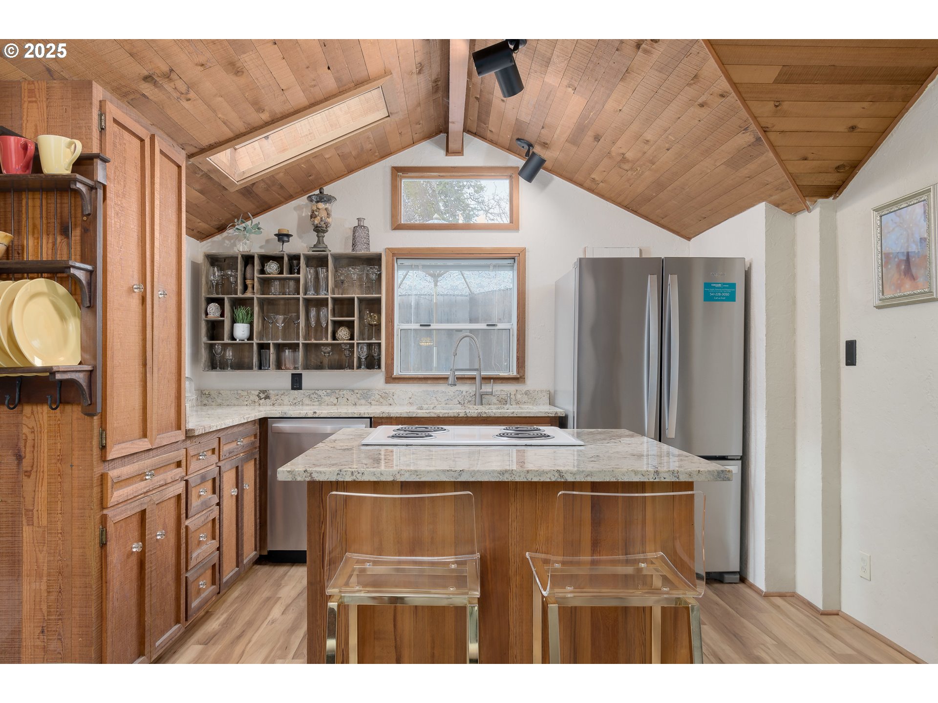 25 West 36th Avenue Eugene, OR 97405 - Photo 11 of 33 a view of kitchen island with stainless steel appliances wooden floor dining table and chairs