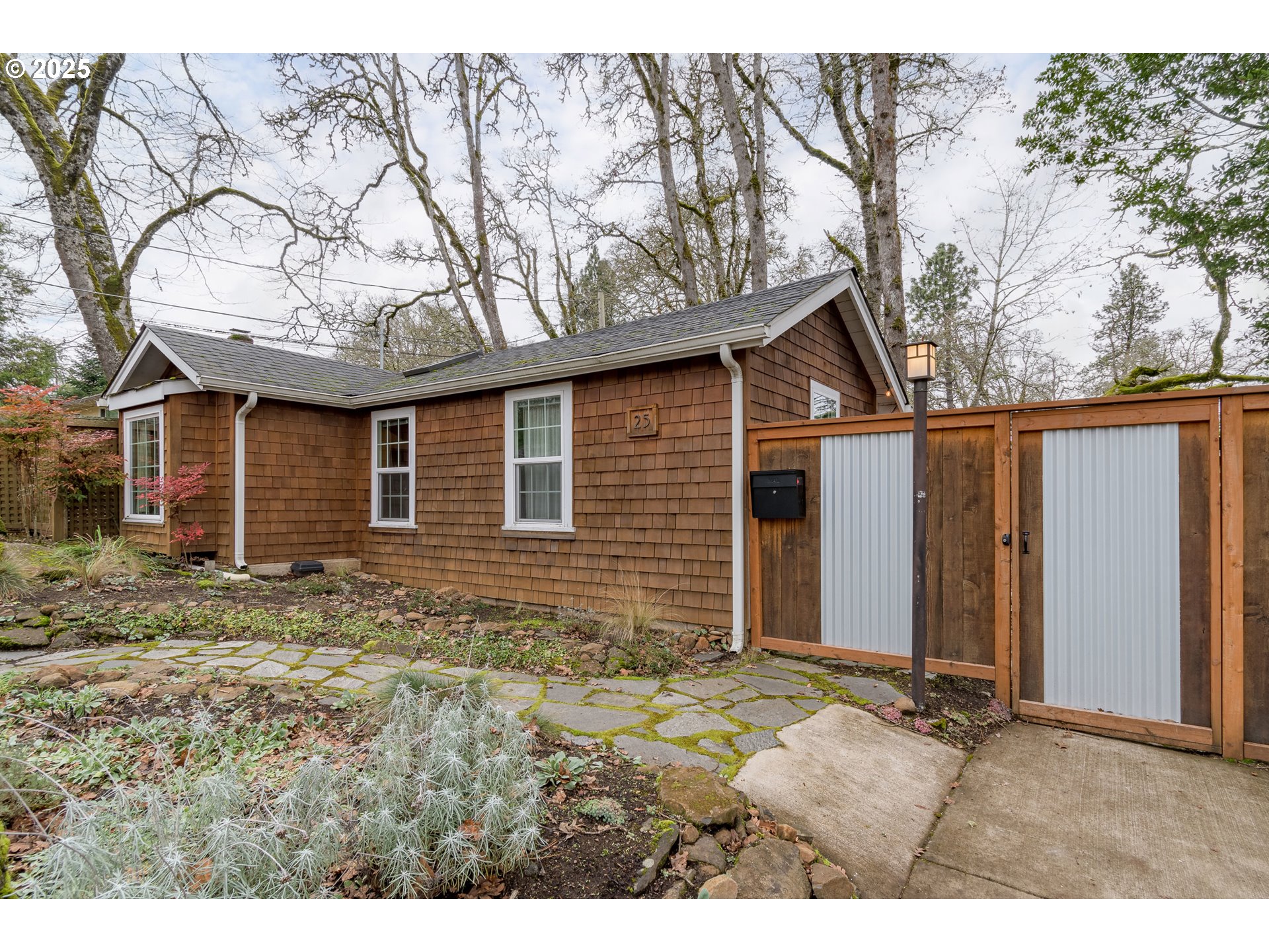 25 West 36th Avenue Eugene, OR 97405 - Photo 2 of 33 a backyard of a house with large trees and wooden fence