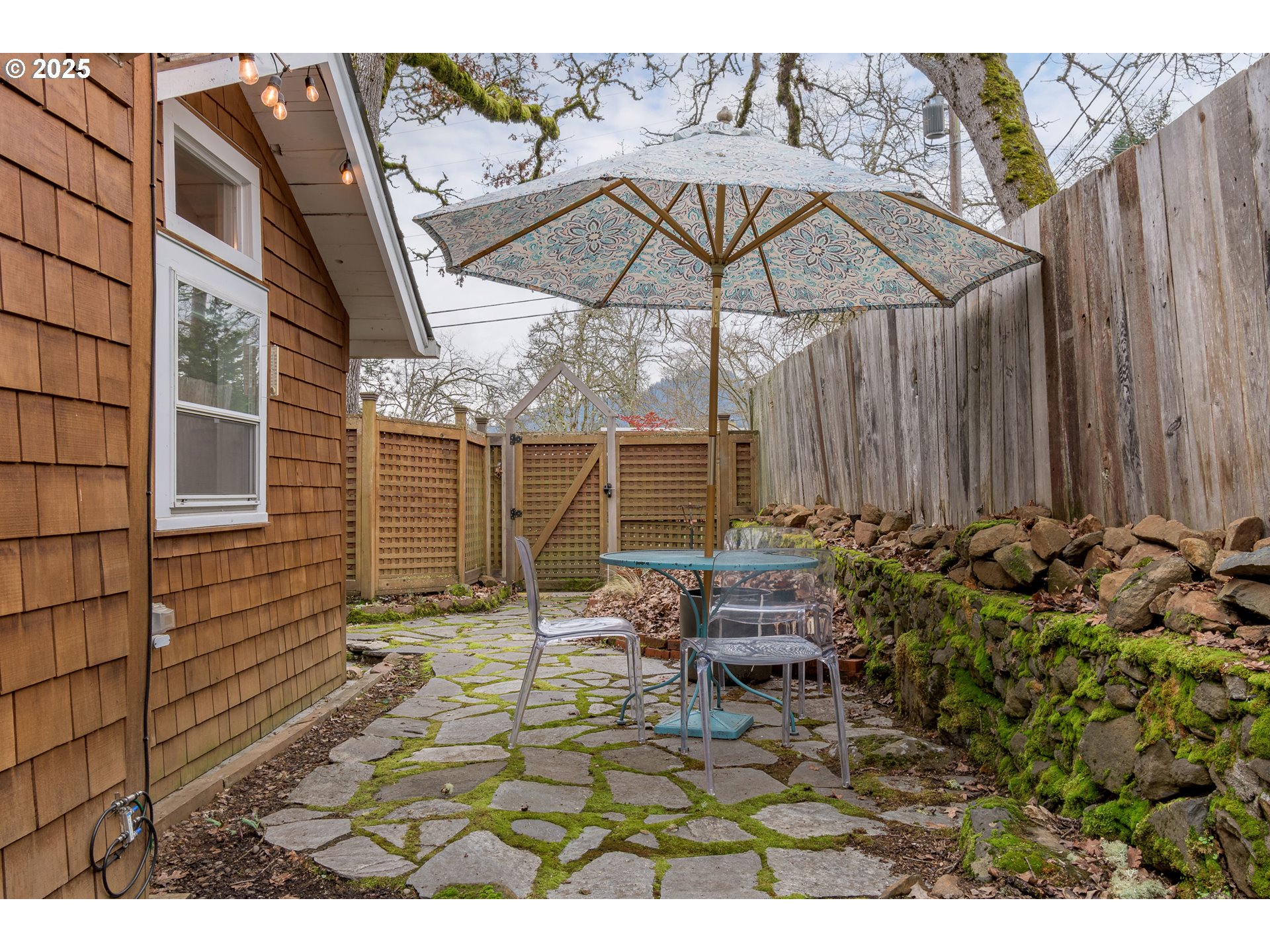 25 West 36th Avenue Eugene, OR 97405 - Photo 32 of 33 a view of a patio with table and chairs under an umbrella