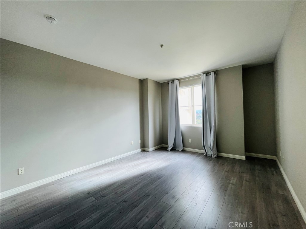 6800 Corbin Avenue Reseda, CA 91335 - Photo 15 of 37 an empty room with wooden floor and windows