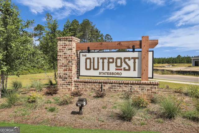 a sign broad in front of a road