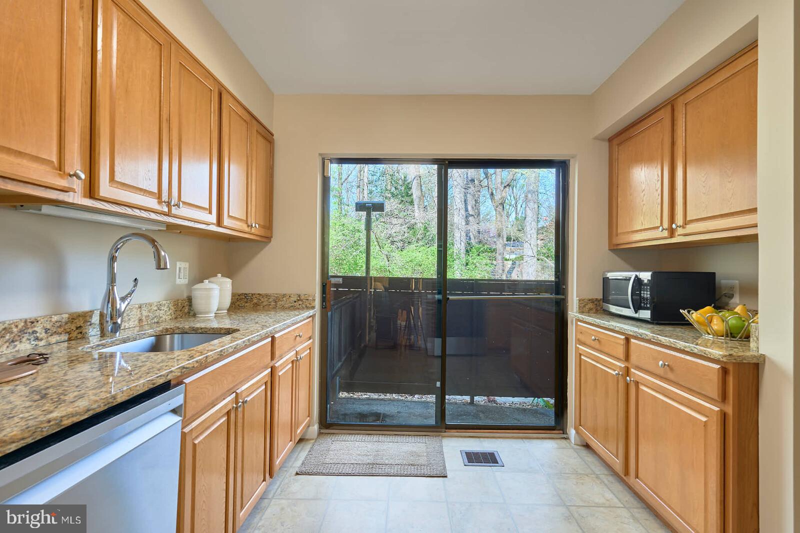 9238 Three Oaks Drive Silver Spring, MD 20901 - Photo 12 of 42 a kitchen with stainless steel appliances granite countertop a refrigerator a sink dishwasher stove and cabinets