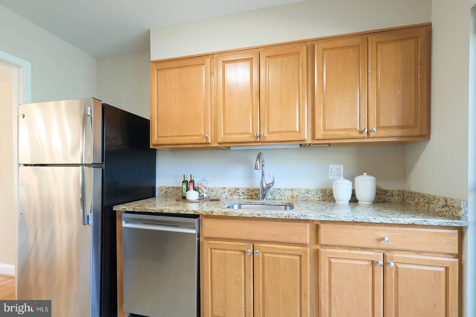 9238 Three Oaks Drive Silver Spring, MD 20901 - Photo 13 of 42 a kitchen with stainless steel appliances granite countertop a refrigerator sink and cabinets