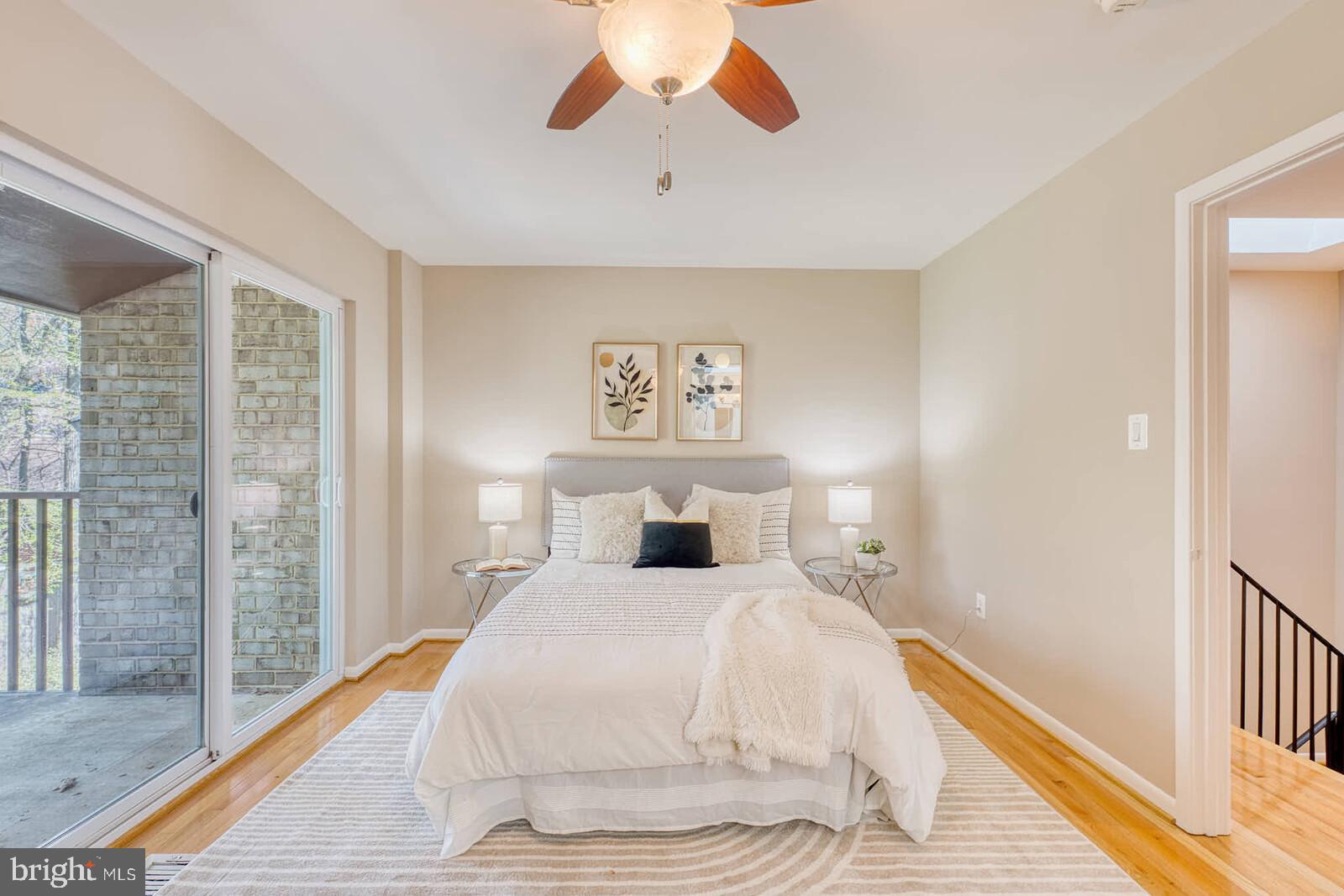 9238 Three Oaks Drive Silver Spring, MD 20901 - Photo 16 of 42 a bedroom with a large bed and a chandelier