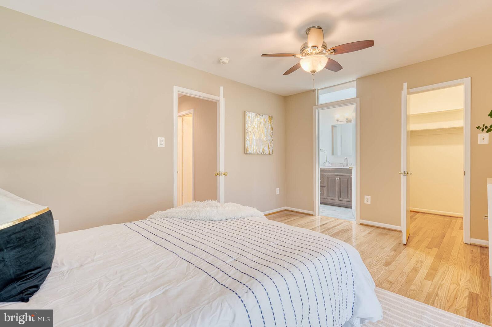 9238 Three Oaks Drive Silver Spring, MD 20901 - Photo 19 of 42 a bedroom with a large bed a chandelier and a window