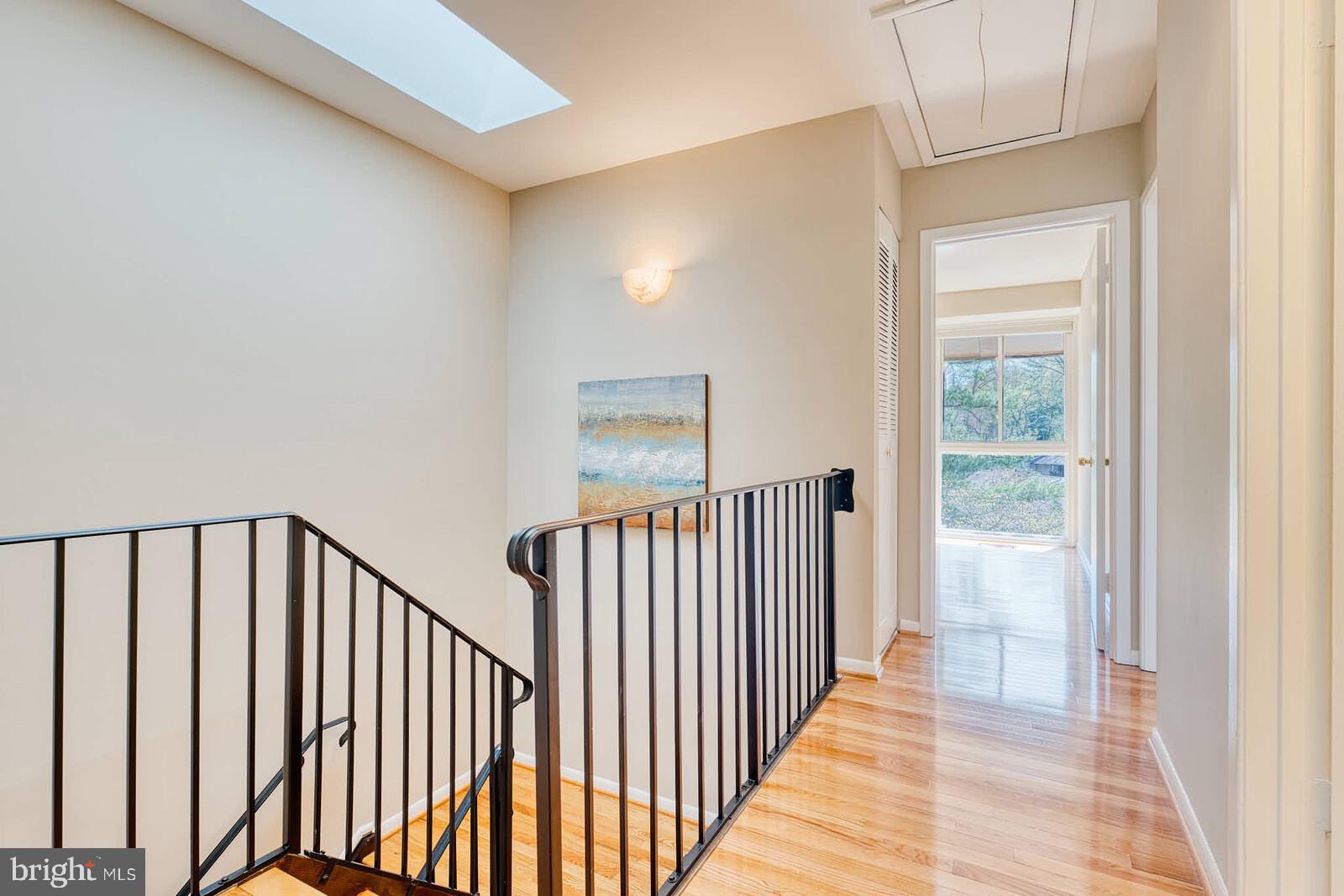 9238 Three Oaks Drive Silver Spring, MD 20901 - Photo 25 of 42 a view of a hallway with wooden floor and windows