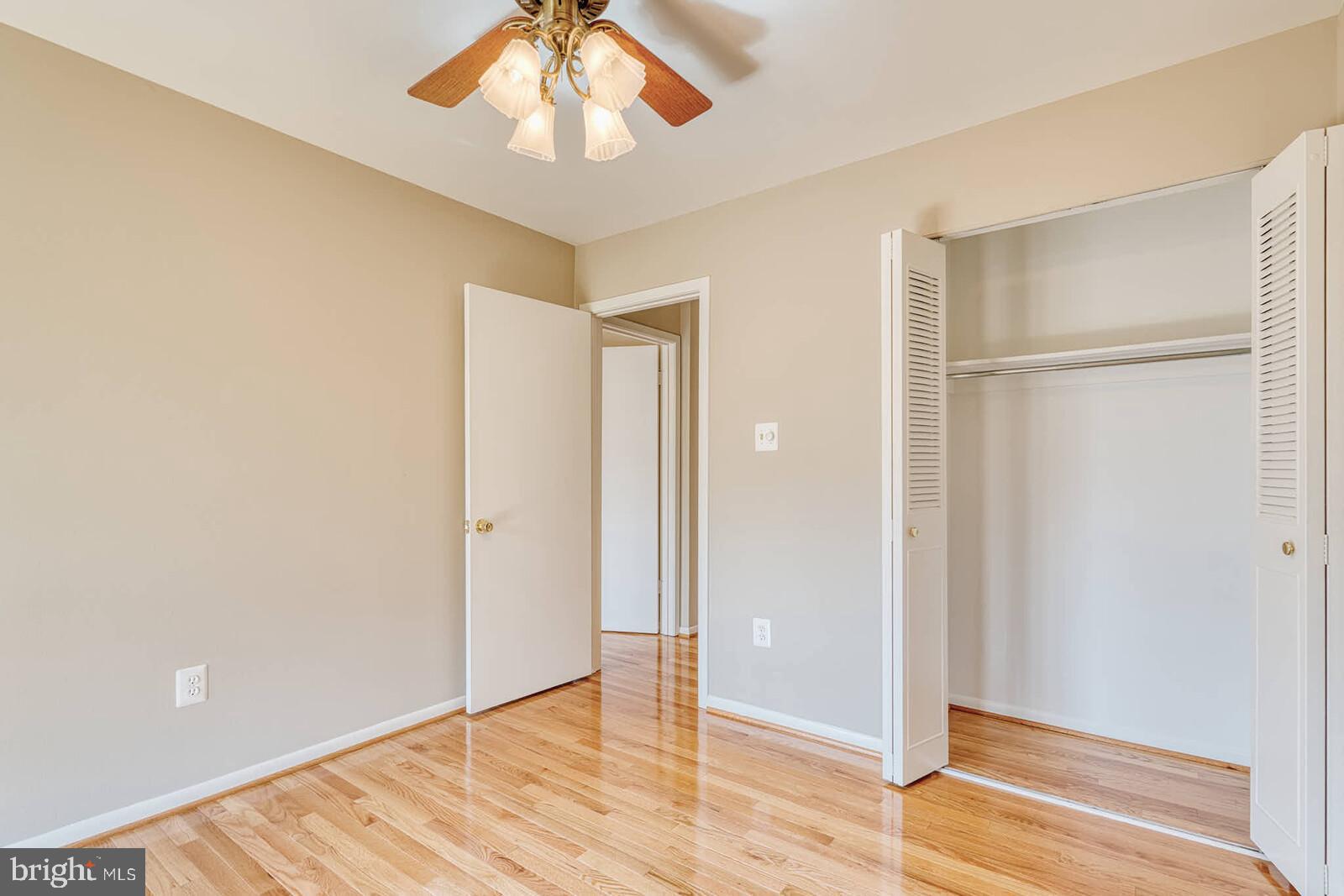 9238 Three Oaks Drive Silver Spring, MD 20901 - Photo 27 of 42 a view of an empty room with wooden floor