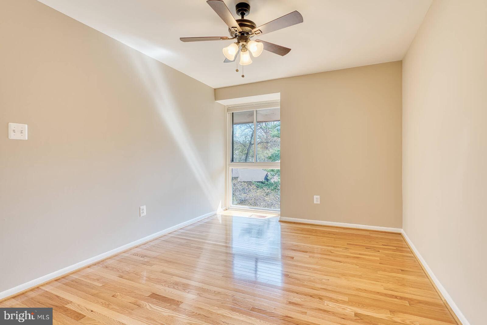 9238 Three Oaks Drive Silver Spring, MD 20901 - Photo 30 of 42 a view of an empty room with window and wooden floor