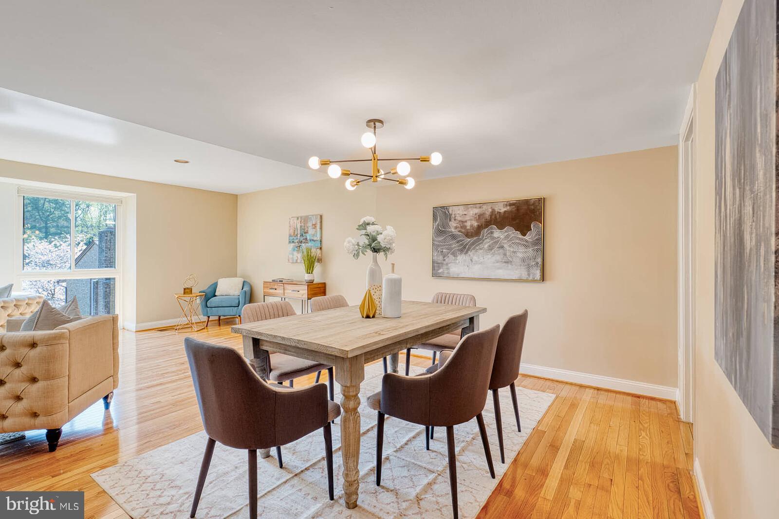 9238 Three Oaks Drive Silver Spring, MD 20901 - Photo 3 of 42 a view of a dining room with furniture and wooden floor