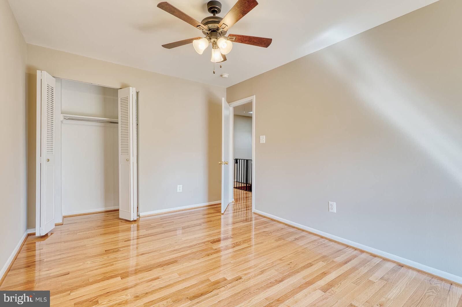 9238 Three Oaks Drive Silver Spring, MD 20901 - Photo 31 of 42 a view of an empty room with wooden floor