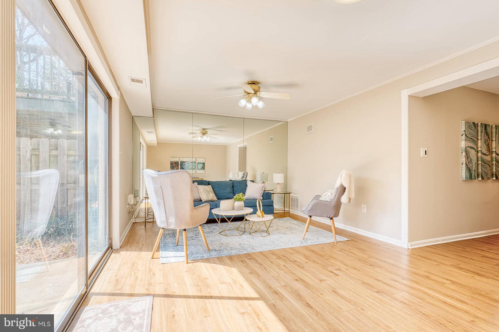 9238 Three Oaks Drive Silver Spring, MD 20901 - Photo 33 of 42 a view of a dining room with furniture wooden floor and a chandelier