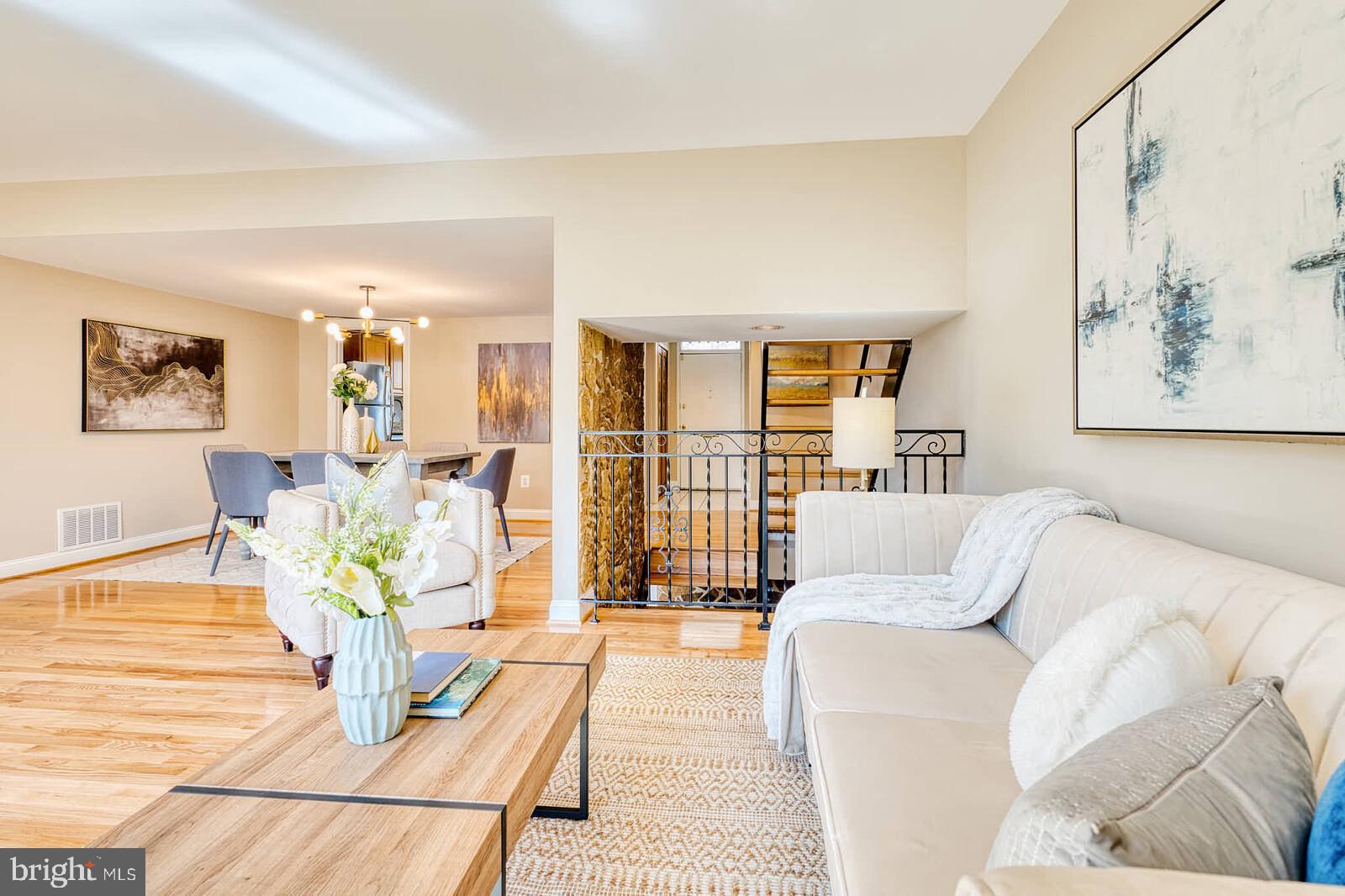 9238 Three Oaks Drive Silver Spring, MD 20901 - Photo 8 of 42 a living room with furniture floor to ceiling window and a potted plant