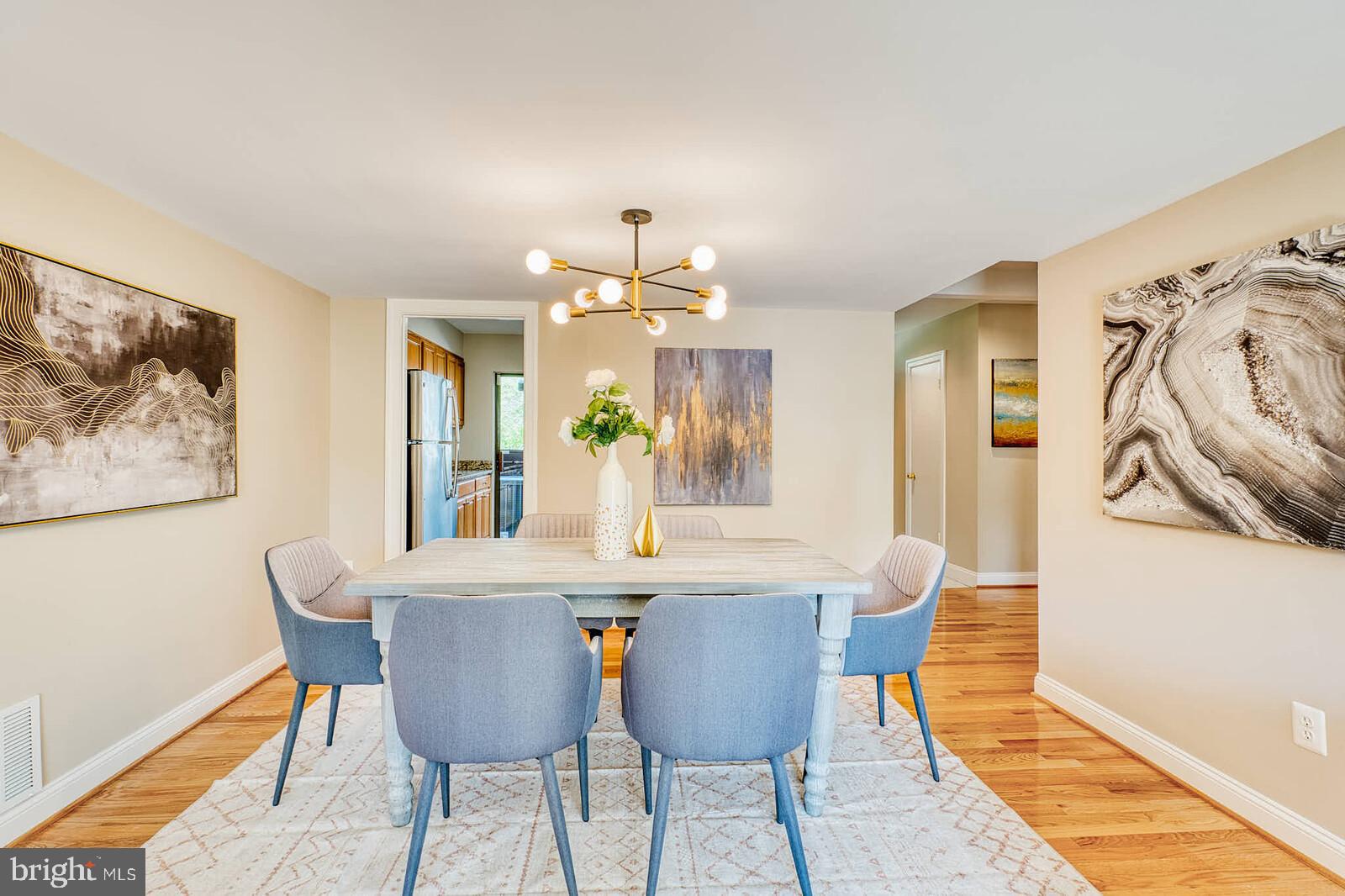 9238 Three Oaks Drive Silver Spring, MD 20901 - Photo 9 of 42 a view of a dining room with furniture and wooden floor