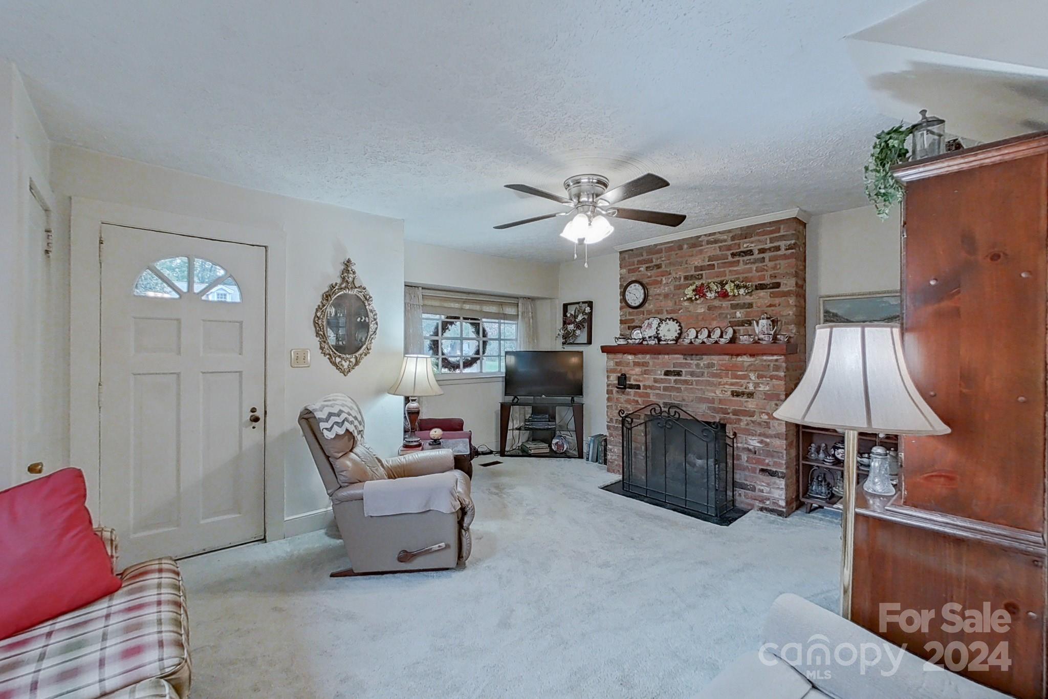 613 Dellinger Road Shelby, NC 28152 - Photo 2 of 19 a living room with furniture and a fireplace