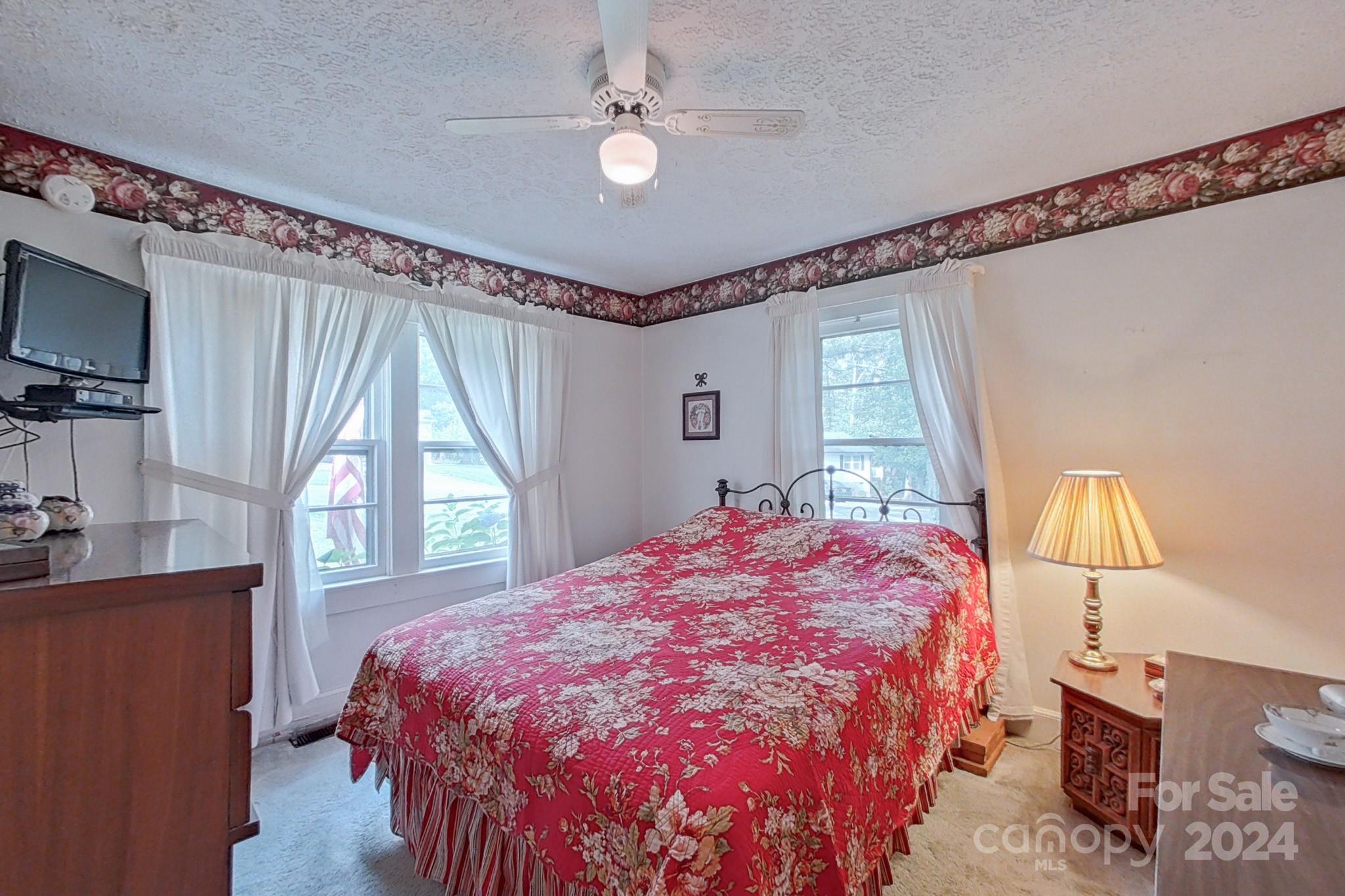 613 Dellinger Road Shelby, NC 28152 - Photo 8 of 19 a bedroom with a bed window and a flat tv screen