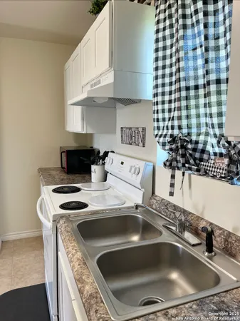 a kitchen with a sink and a stove