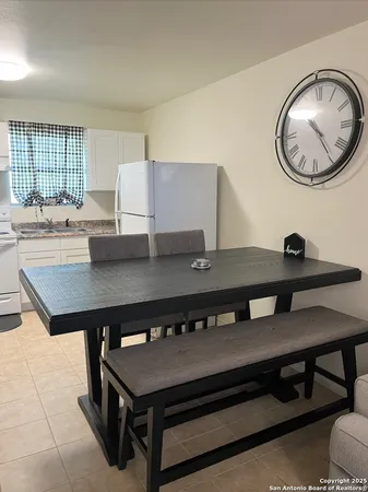 a view of a kitchen with a table and chairs