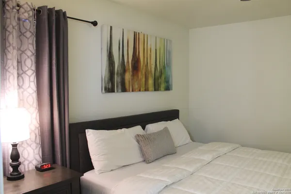 a bedroom with a bed and a window